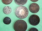 several different types of coins on a green surface
