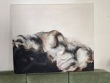 a painting on the wall above a green couch in a living room