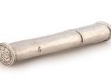 an antique silver cigarette case on a white background