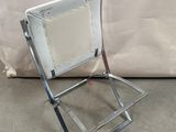 a metal chair that has a mirror on it