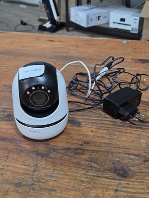 a camera that is sitting on a table next to a charger