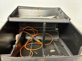 a metal box with wires in it on the floor