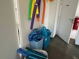 a lot of different colored hoses hanging on the wall