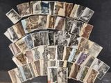 a lot of old photos of people on a table