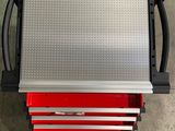 a red tool box sitting on top of a metal table