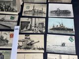some old photos of ships and boats are displayed on a table