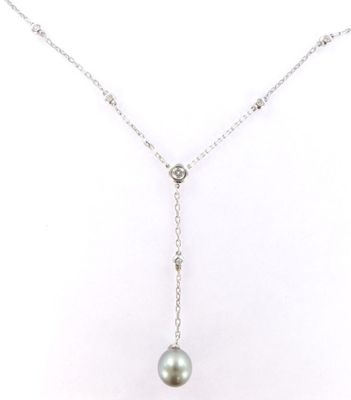 a white pearl and diamond necklace on a silver chain