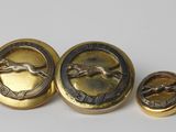 a close up of three buttons with a horse on them