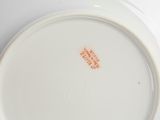 a white plate with an orange design on it