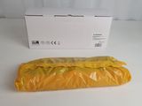 an orange plastic bag sitting on top of a table next to a white box