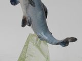 une figurine représentant un poisson posé sur un rocher