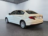 the back of a white car is parked in a large room