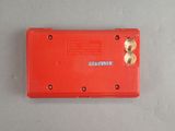a small red box with a yellow button on it