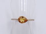 a close up of a ring with a yellow topaz stone on it