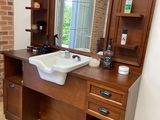 a bathroom with a sink and a mirror on the wall