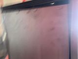 a television sitting on top of a table in a room