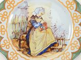 a plate with a picture of a woman and a cat on it