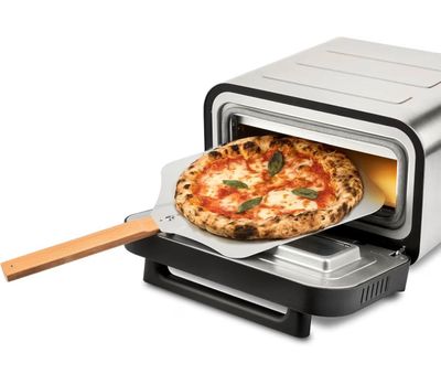 a small pizza being taken out of a toaster oven