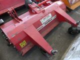 a red machine that is sitting on the side of the road