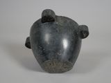 a black vase with a bear head on it