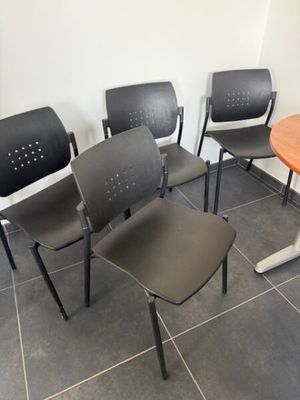 quatre chaises et une table dans un coin de la pièce
