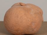 a clay sculpture of an apple sitting on a table