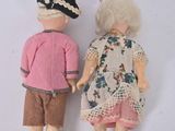 two dolls that are standing next to each other