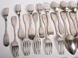 a lot of forks and spoons that are on the table