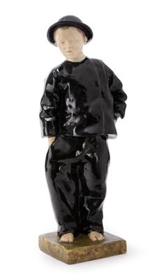 black and white figurine of a boy in a suit and hat