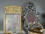 a picture of a picture frame, a mirror, and a teapot on a table