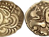 a close up of two gold coins with designs on them