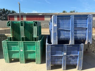 many plastic crates stacked on top of each other in the dirt