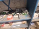 a blue shelf filled with assorted items in a room