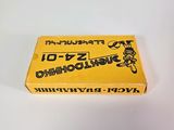 a close up of a yellow box of toothbrushes on a white surface