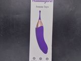 packaging of a purple electric vibrating toy on a black surface