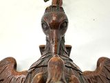 a wooden sculpture of a bird with a bird on it ' s head