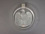 une image représentant une pièce d'argent sur laquelle figure un aigle