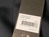 the label on the back of a black shirt is attached to a tag