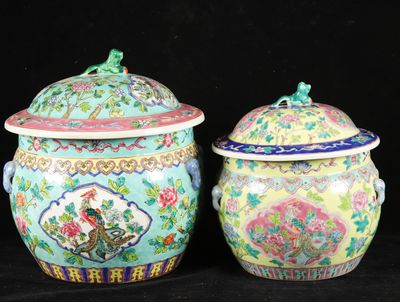 pair of chinese vases with lids on a black background