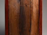 an old wooden picture frame with a metal handle on a gray background
