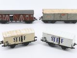 four toy train cars are lined up in a row on a white surface