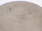 someone is writing on the bottom of a bowl with writing on it