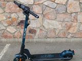 a scooter that is parked in front of a stone wall