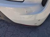 a close up of a car ' s bumper with a denting on it