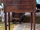 a small wooden table with a drawer on top of it