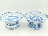 pair of blue and white porcelain bowls on pedestals on a white background