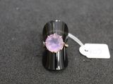 purple amethorate ring on a black surface with a price tag