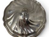 a silver plate with a lady on it on a white surface