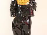 a figurine of a man wearing a hat and a black suit