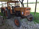 a tractor that is parked under a shelter